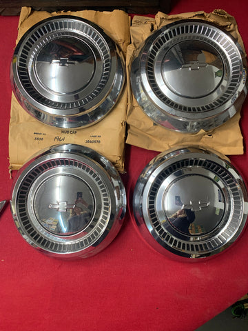 1964 CHEVROLET NOS PASS HUBCAPS. ALL FOUR
